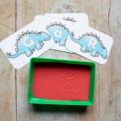 Dinosaur Alphabet Cards from the Rainy Day Mum Print and Play store in use with a sand tray
