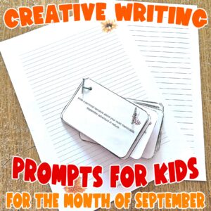 September Creative Writing Prompts printable for Kids - showing the cards laminated and attached with treasury tags on top of the 2 different journal pages including in the printable set.