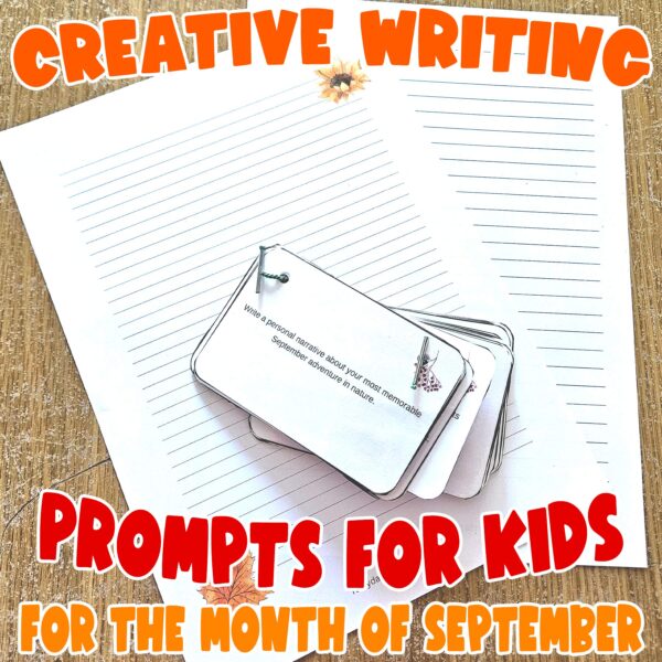 September Creative Writing Prompts printable for Kids - showing the cards laminated and attached with treasury tags on top of the 2 different journal pages including in the printable set.